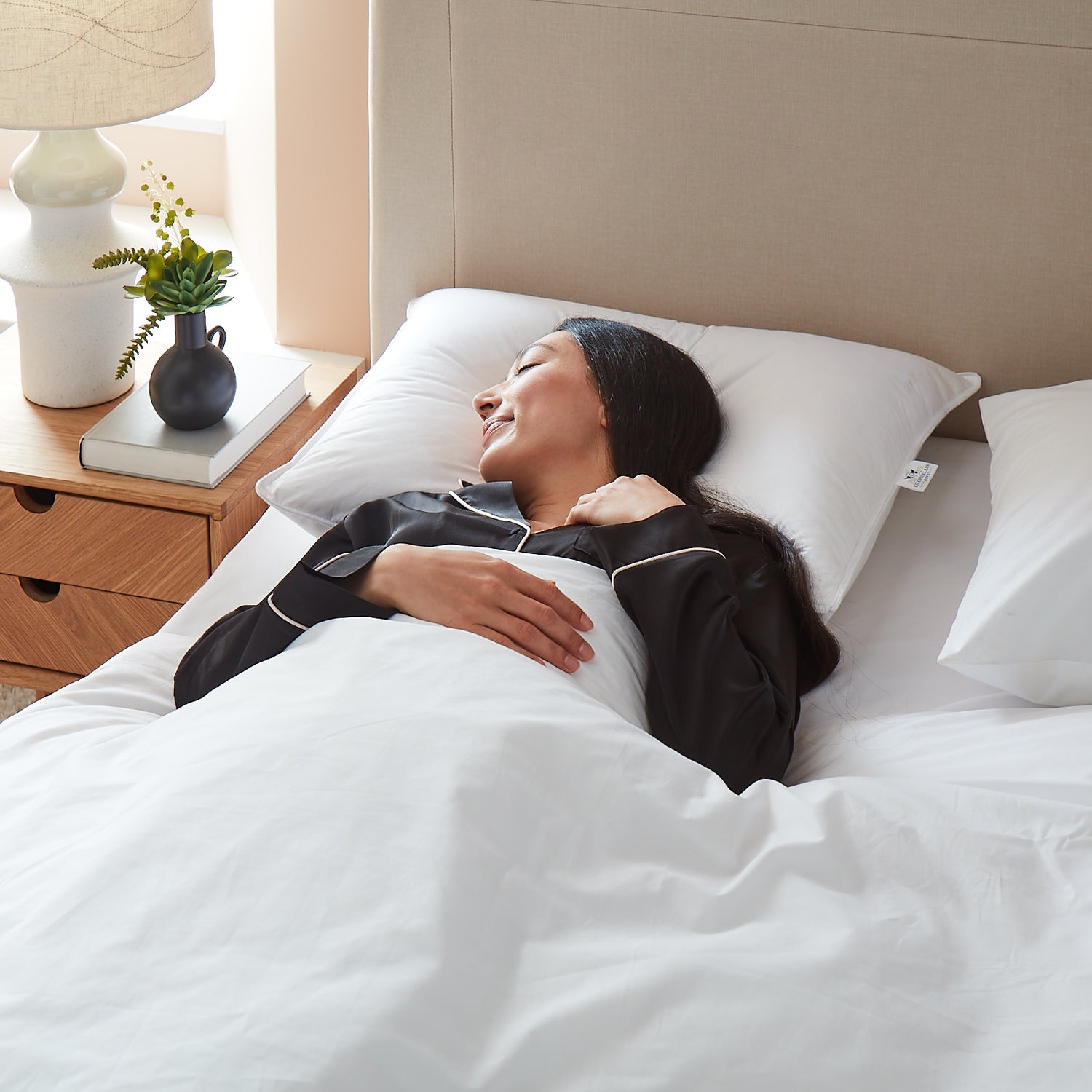 Model back-sleeping on Chamberlain Down Pillow