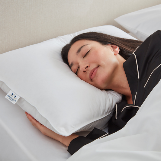 Model sleeping on Chamberlain Down pillow on side